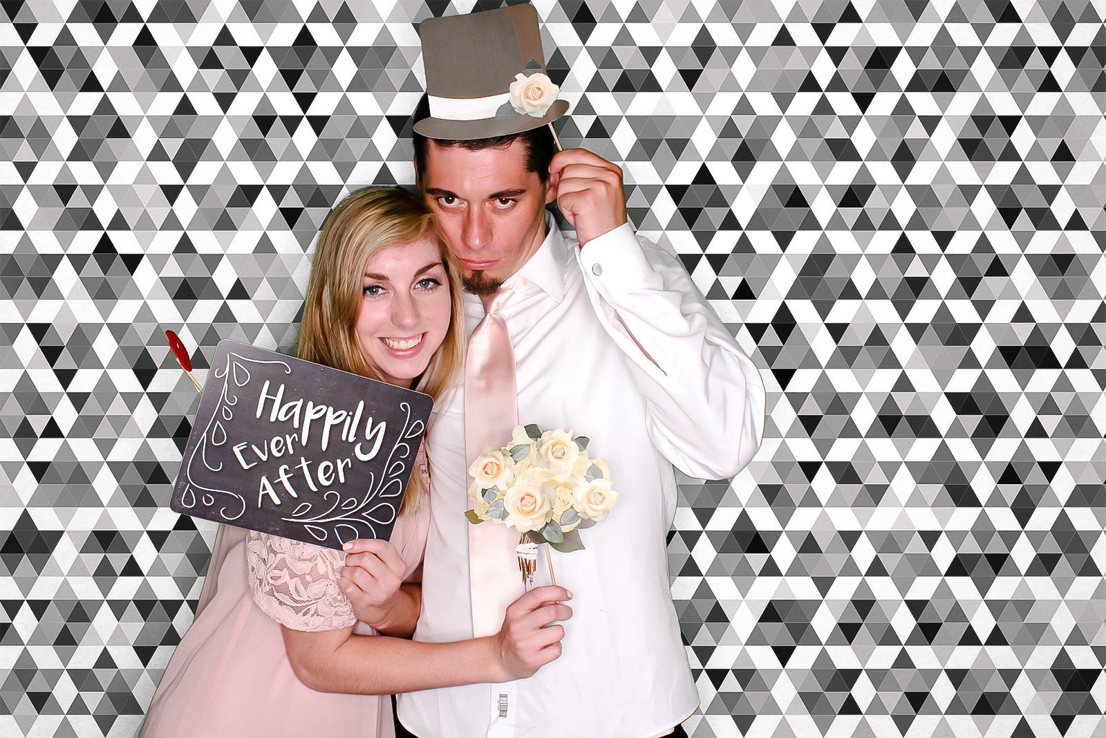 Couple Taking Picture From Selfie Booth With Props